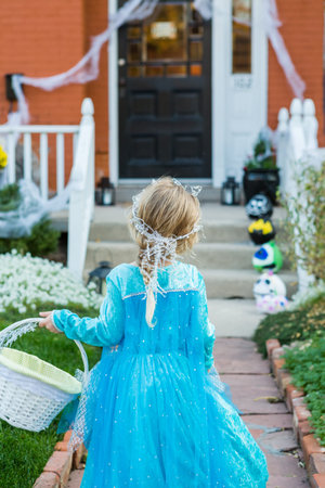 Trick or treating in costumes on Halloween night.の写真素材