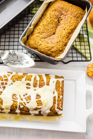 Homemade pumpkin bread with orange glazing on top.