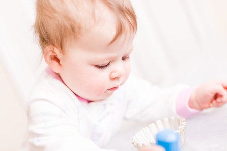 Cute baby girl playing with cubes on the floor.の写真素材