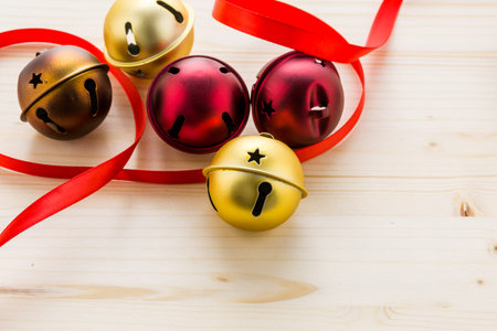 Multicolor jingle bells with red ribbon.