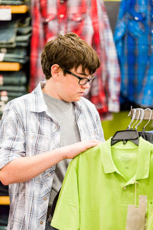 Teenager shopping for new clothes at the department stpre.の写真素材