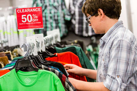 Teenager shopping for new clothes at the department stpre.のeditorial素材