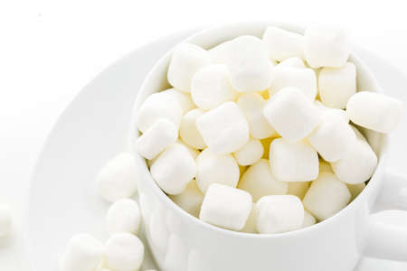 Small round white marshmallows on a white backgrouns.の写真素材