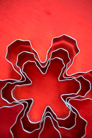 Different size metal cookie cutters in shape of snow flakes.の写真素材