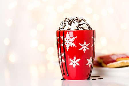 Hot chocolate garnished with whipped cream and drizzled with chocolate.の写真素材