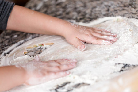 Kids making cookies with family for Christmas.