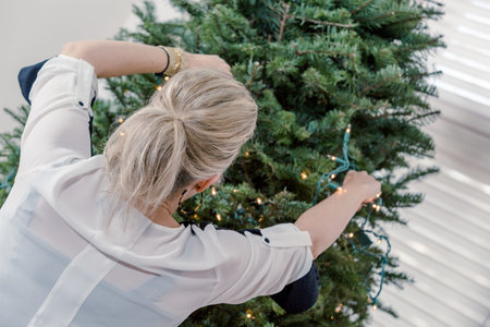 Family decorating beautiful live Christmas tree.の写真素材