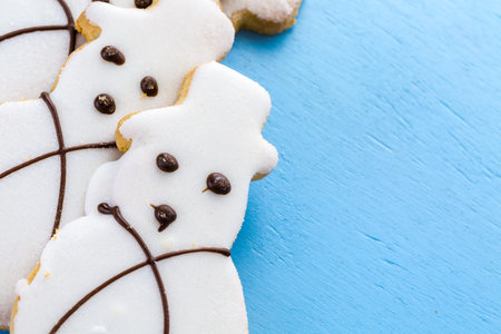 Frosted white sugar cookies in shape of snowman.