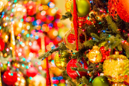 Christmas tree decorated with multicolor ornaments.の写真素材