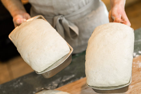 Young baker preparing artisan sourdough bread.