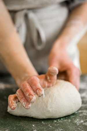 Young baker preparing artisan sourdough bread.