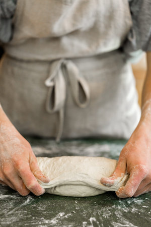 Young baker preparing artisan sourdough bread.の写真素材