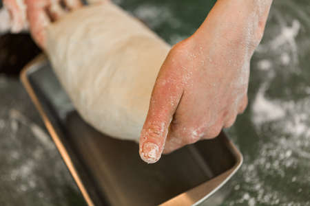 Young baker preparing artisan sourdough bread.の写真素材