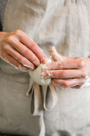 Young baker preparing artisan sourdough dinner rolls.の写真素材