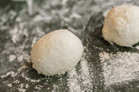 Young baker preparing artisan sourdough dinner rolls.の写真素材
