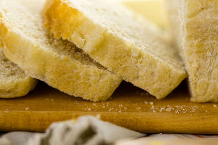 Freshly baked sourdough bread sliced on cutting board.の写真素材