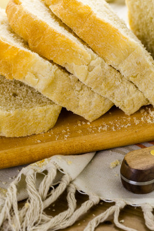 Freshly baked sourdough bread sliced on cutting board.