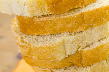 Freshly baked sourdough bread sliced on cutting board.