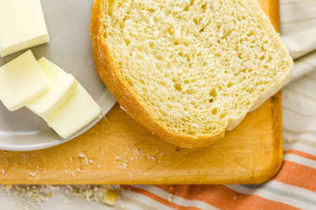Freshly baked sourdough bread sliced on cutting board.