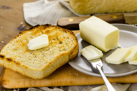 Toasted slices of freshly baked sourdough bread with butter.の写真素材