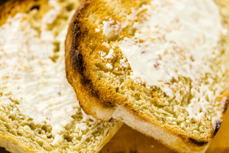 Toasted slices of freshly baked sourdough bread with butter.の写真素材
