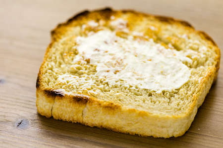 Toasted slices of freshly baked sourdough bread with butter.の写真素材
