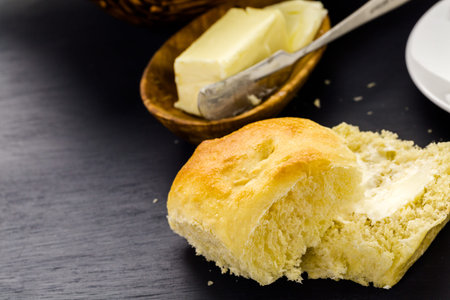 Freshly baked sourdough dinner rolls on black  background.の写真素材