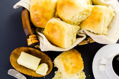 Freshly baked sourdough dinner rolls on black  background.の写真素材