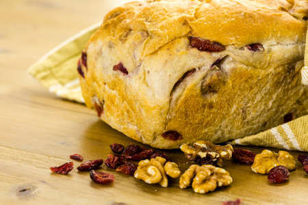 Freshly baked sourdough cranberry nut bread on a white background.の写真素材