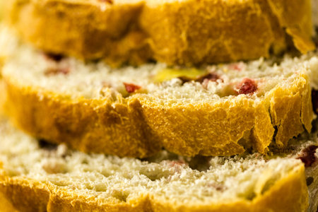Freshly baked sliced sourdough cranberry nut bread on the table.の写真素材