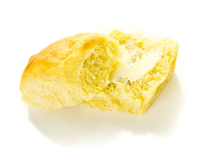 Freshly baked sourdough dinner rolls on a white background.