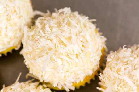 Fresh coconut cupcakes on the tray.の写真素材