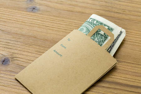 Tips for services in a small envelope on the table.の写真素材
