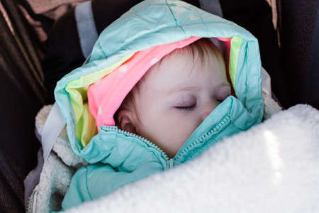 Cute toddler girl sleeping in her stroller.の写真素材