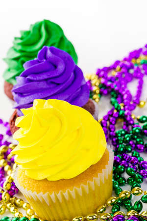 Cupcakes decorated with bright color icing for Mardi Gras party.の写真素材