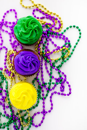 Cupcakes decorated with bright color icing for Mardi Gras party.の写真素材