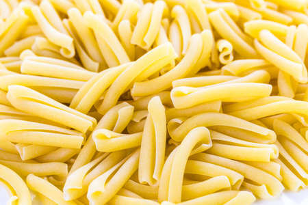 Organic dry pasta on a white background.の写真素材