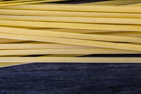 Variety og organic dry pasta on wood board.