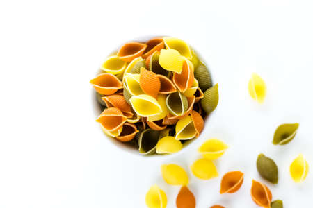 Multicolor shell pasta with tomato and spinach.の写真素材