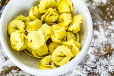 Making homemade four cheese tortellini with farm fresh produce.の写真素材
