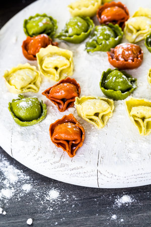 Making fresh rainbow cheese tortellini with organic produce.の写真素材