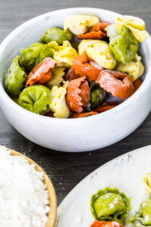 Making fresh rainbow cheese tortellini with organic produce.の写真素材