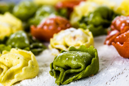 Making fresh rainbow cheese tortellini with organic produce.の写真素材