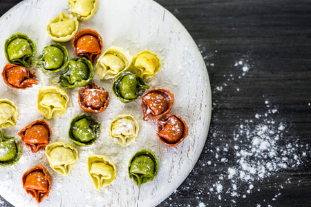 Making fresh rainbow cheese tortellini with organic produce.の写真素材
