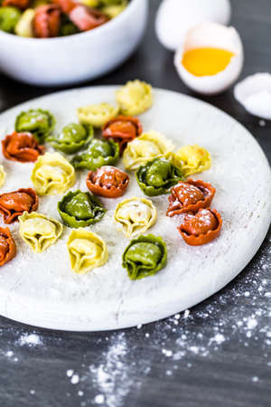Making fresh rainbow cheese tortellini with organic produce.の写真素材