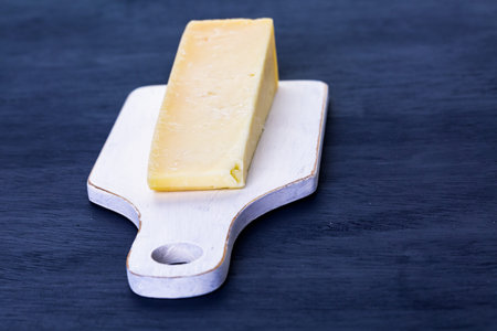 Slice of parmesan cheese on the board.の写真素材