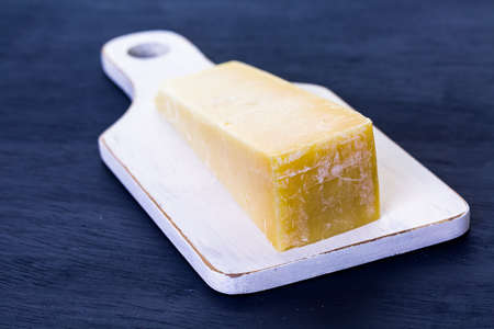 Slice of parmesan cheese on the board.の写真素材