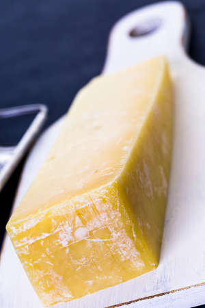 Slice of parmesan cheese on the board.の写真素材