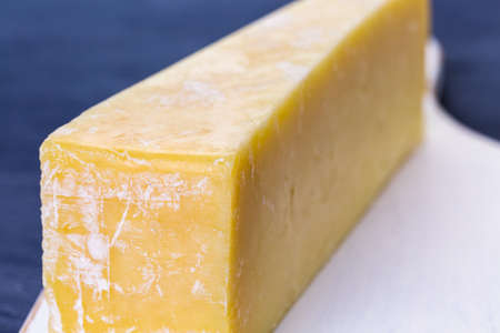 Slice of parmesan cheese on the board.の写真素材