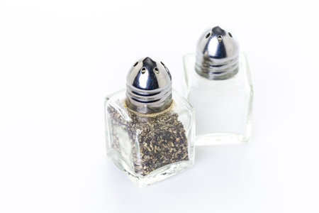 Glass salt an pepper shakers on a white background.